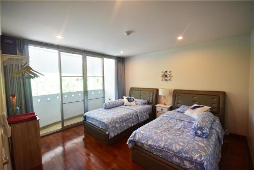 Postel nebo postele na pokoji v ubytování Hua Hin Beachfront Condo