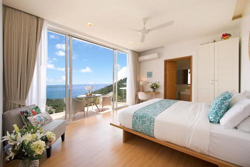 a bedroom with a large bed and a large window at Stunning Blue Sea Villa 3BDRM Infinity Pool in Chaweng Noi Beach