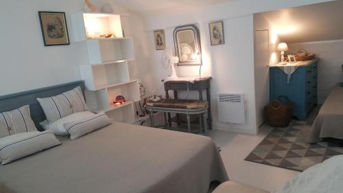 a bedroom with a bed and a sink in it at Blue Ocean in Moliets-et-Maa