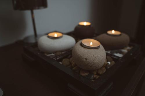 a group of candles sitting on a table with rocks at Fauzia B&B in Hamrun
