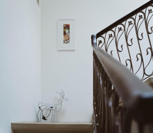 a stairway with a metal railing and a picture at Fauzia B&B in Hamrun
