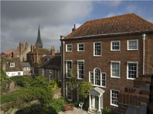 an old brick house in a city with a church at East Pallant Bed and Breakfast, Located in Large Georgian Townhouse in Central Chichester in Chichester
