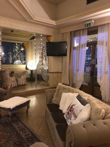 a living room with a couch and a flat screen tv at Hotel Vandelli in Pavullo nel Frignano