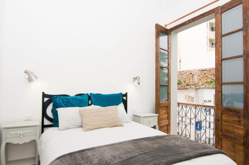 a bedroom with a bed and a large window at Residencial LaMar in Santa Cruz de la Palma