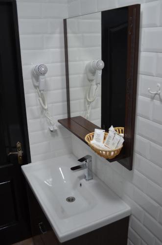 a bathroom with a white sink and a mirror at Motel Chalet in Vita-Pochtovaya