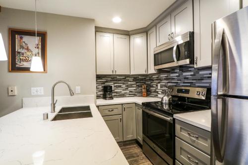 a kitchen with a sink and a refrigerator at La Residence V #S02 Condo in Mammoth Lakes