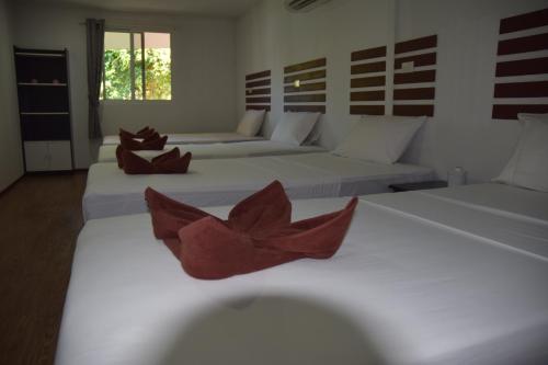 a room with two beds with red bowls on them at Coco's Guest House in Phi Phi Don