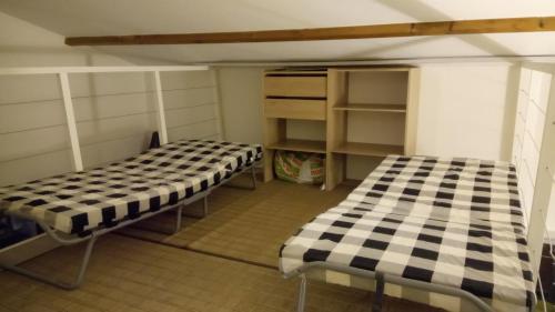 Tempat tidur dalam kamar di MARE BELLU AGOSTA PLAGE