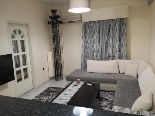 ein Wohnzimmer mit einem Sofa und einem TV in der Unterkunft Thiseio Home in Athen
