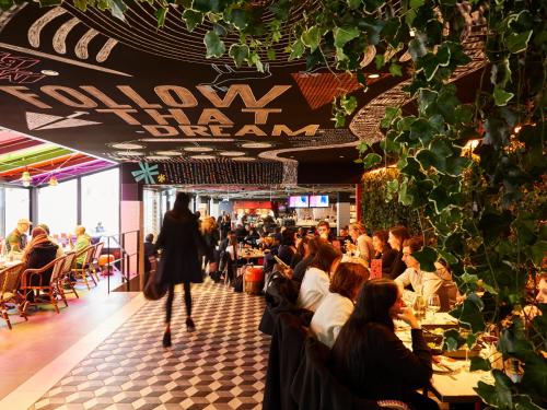 a crowd of people sitting at tables in a restaurant at Mama Shelter Toulouse in Toulouse