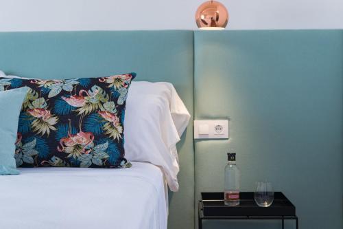 a bedroom with a bed with a pillow and a night stand at Divina Suites Hotel Boutique - Adults only in Ciutadella