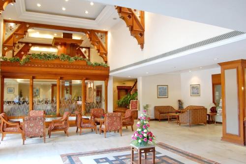 a lobby of a hotel with a christmas tree on a table at Comfort Inn Sunset in Ahmedabad