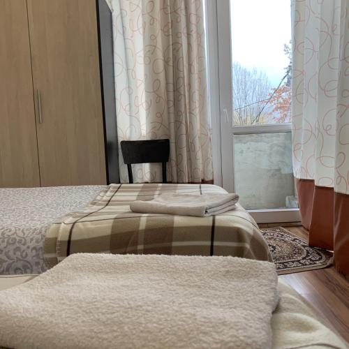 a bedroom with two beds and a window at Your House In Tbilisi in Tbilisi City