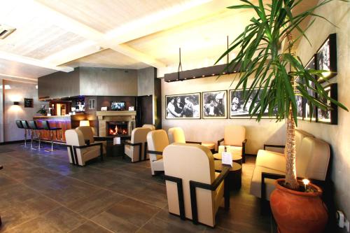 a waiting room with chairs and a fireplace at Hotel de la Jamagne & Spa in Gérardmer