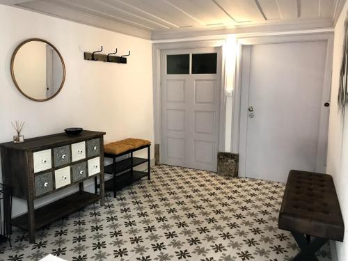 a room with a door and a table and a mirror at Casa Santa Luzia - Historic Centre in Guimarães