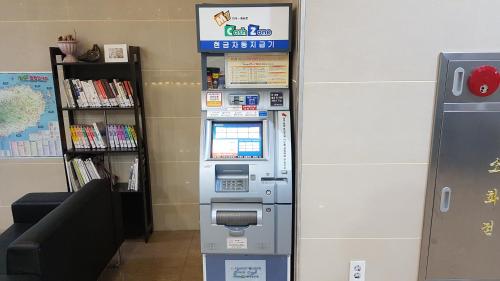 a atm machine in the corner of a room at Hotel Aroha in Seogwipo