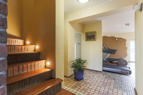 a hallway with stairs and a potted plant at Willa Bryza in Gdynia