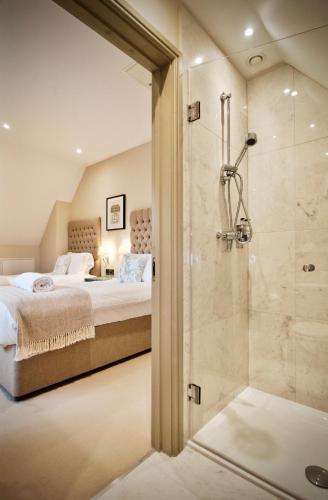 a bedroom with two beds and a shower at Blacknest Golf and Country Club in Alton