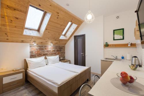 a small bedroom with a bed and a kitchen at 7 Apartments in Lviv