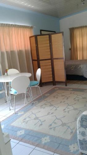 a room with a table and chairs and a bed at 36 Df Strauss Street in Kleinmond