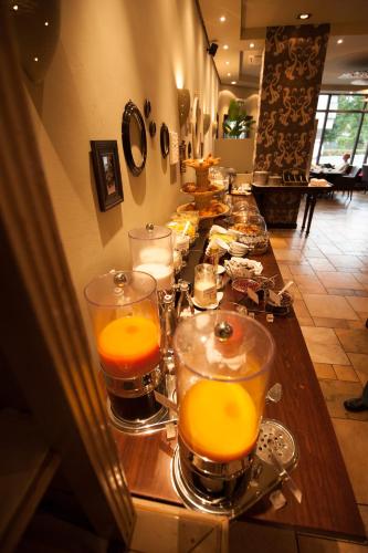 a buffet line with orange juice in glasses on a table at Turm Hotel in Frankfurt/Main