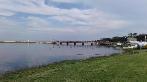 a bridge over a lake with ducks in the water at 36 Df Strauss Street in Kleinmond