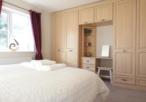 a bedroom with a large white bed and a window at Century House in Gosport
