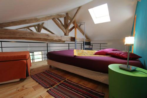 a bedroom with a large bed in a room at Domaine de La Maison d'Aum in Bourrou