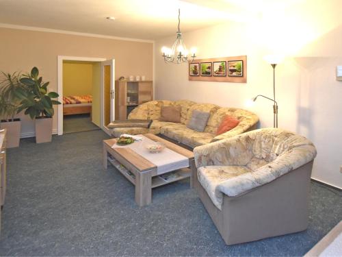 a living room with a couch and a table at Spacious apartment in Harz near ski area in Blankenburg
