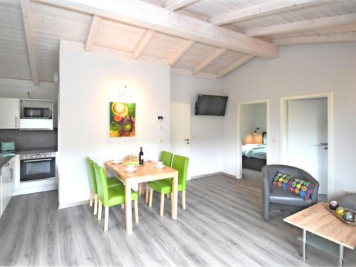 a kitchen and dining room with a table and chairs at holiday home in G ntersberge Harz with wood stove in Harzgerode