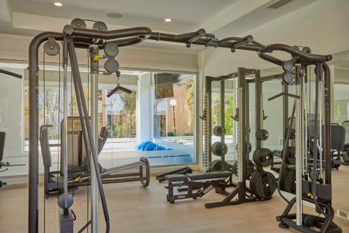a gym with several treadmills and exercise bikes at Bahia Principe Grand Aquamarine - Adults Only All Inclusive in Punta Cana