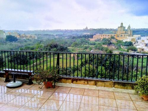 a balcony with a view of a city at Harruba Flt 3 Triq il Gudja in Mġarr