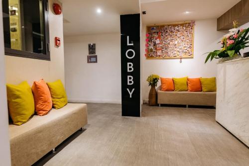 a living room with two couches and a couch at Lucky House Khaosan in Bangkok