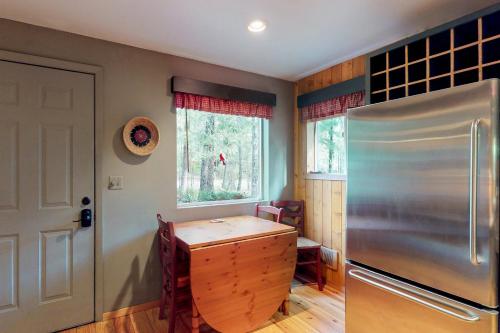 a kitchen with a refrigerator and a table in it at Get Away From It All in Pine Glen