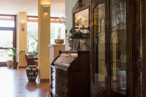 a large wooden cabinet with glass doors in a room at Hotel Relais Pian delle Starze in Marina di Camerota