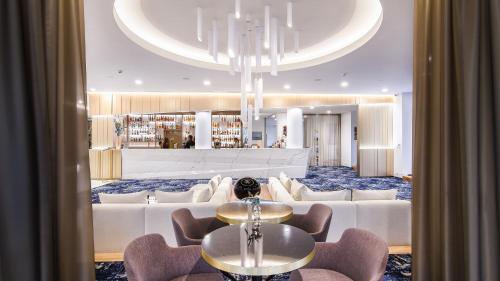 a hotel lobby with a table and chairs at The President in Prague