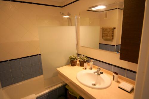 a bathroom with a sink and a mirror and a tub at Attractive Apartment (PA 4-17) in Estepona