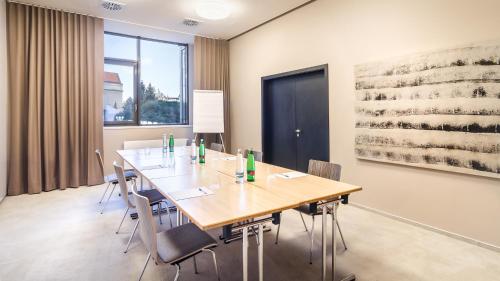 a conference room with a wooden table and chairs at The President in Prague