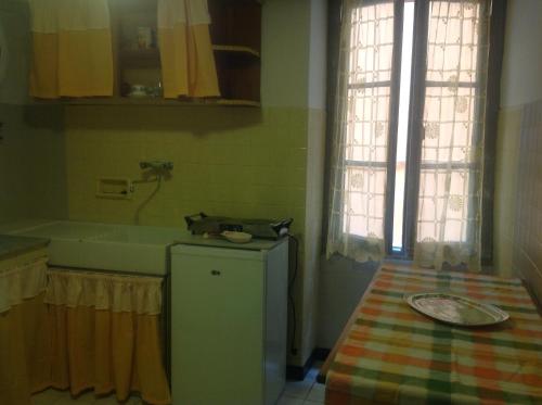 a small kitchen with a sink and a refrigerator at Vista mare vecchia città in Menton