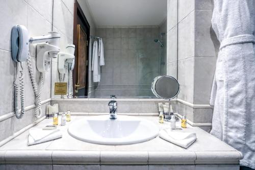 a bathroom with a sink and a mirror at Casa Boyana Boutique Hotel in Sofia