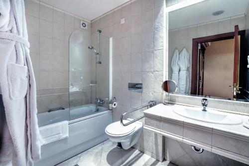 a bathroom with a sink, toilet and bathtub at Casa Boyana Boutique Hotel in Sofia
