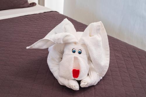 a stuffed animal is laying on a bed at Dream Away Uruaú Beach Residences in Uruau