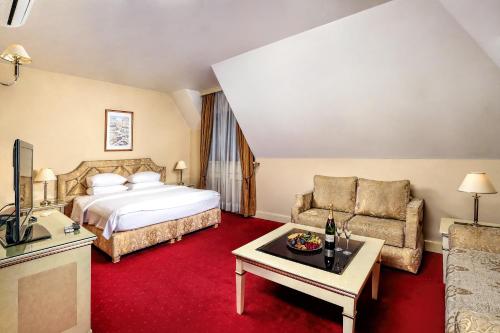 a hotel room with a bed and a couch at Casa Boyana Boutique Hotel in Sofia