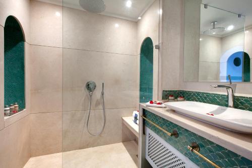 a bathroom with a tub, sink, and shower at Les Jardins De La Médina in Marrakech