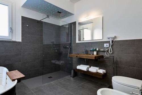 a bathroom with a shower and a toilet and a sink at nautilus b&b suite design in Follonica