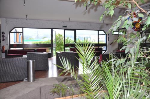 a room with chairs and tables and windows at Jugendherberge Innsbruck - Youth Hostel in Innsbruck