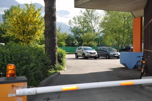 two cars are parked in a parking lot at Jugendherberge Innsbruck - Youth Hostel in Innsbruck