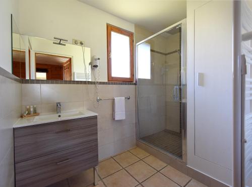 a bathroom with a sink and a shower at Le Camping Grand Cerf in Gimouille