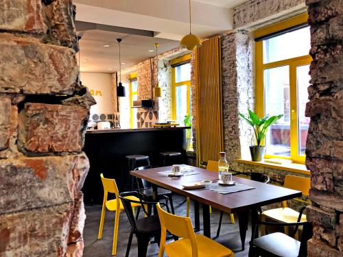 a dining room with a table and chairs in a restaurant at Baraban Hostel in Moscow