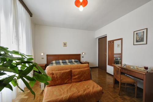 a living room with a couch and a table at Hotel Bertusi in Porretta Terme